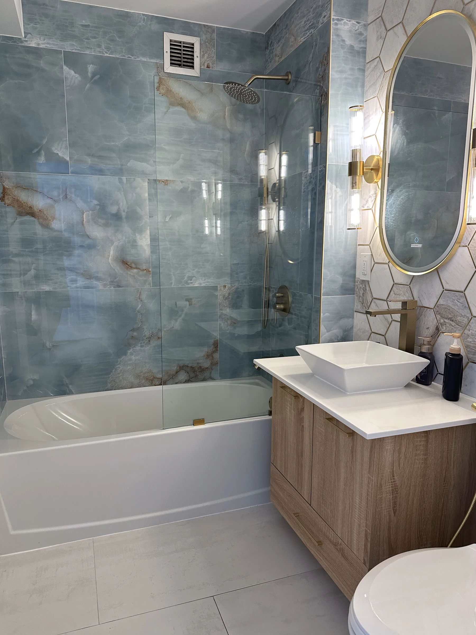 Blue stone-patterned tile and a floating vanity from HKB photography