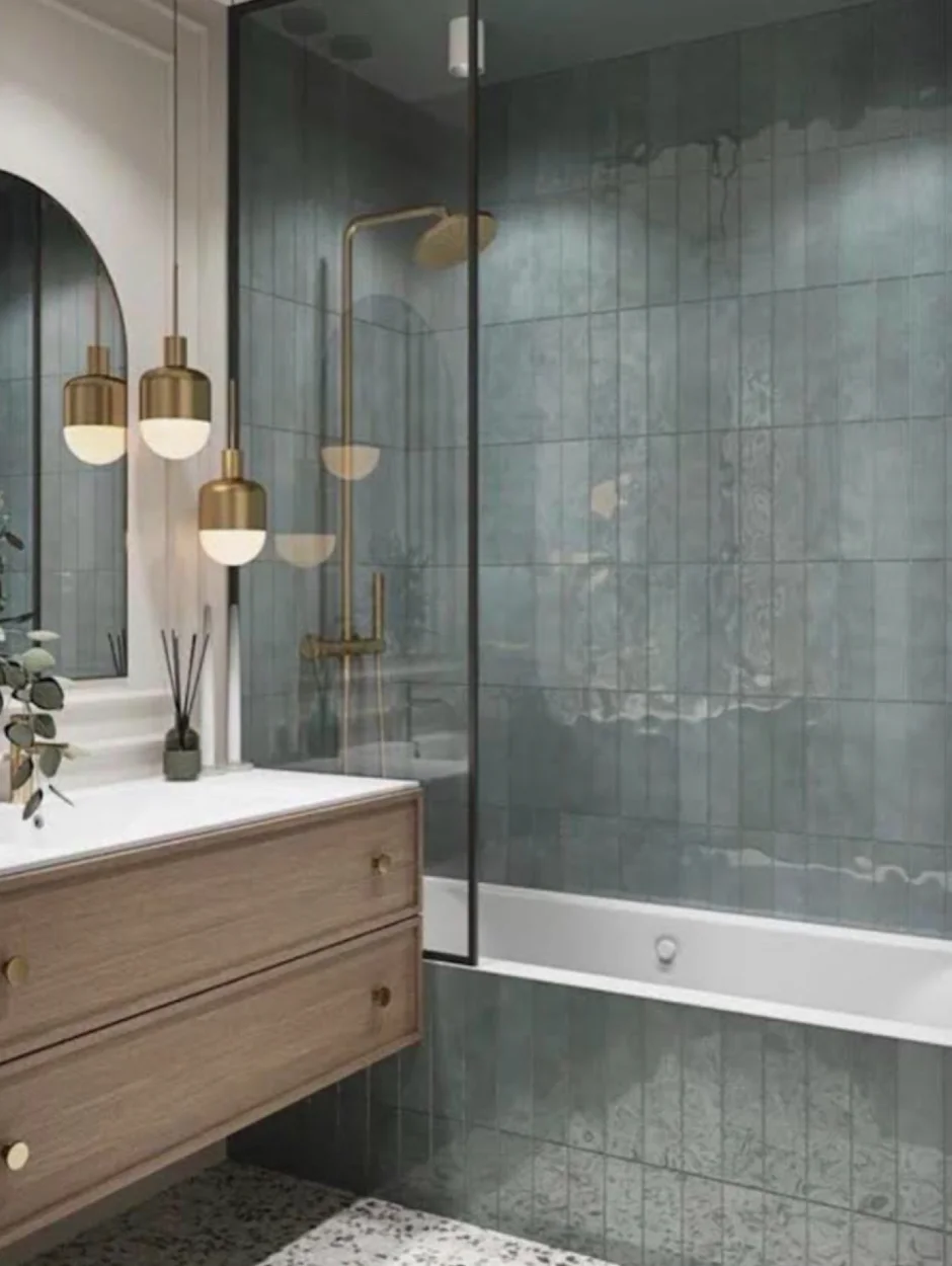 Blue stone tile, brass fittings and a floating vanity in an HKB bathroom