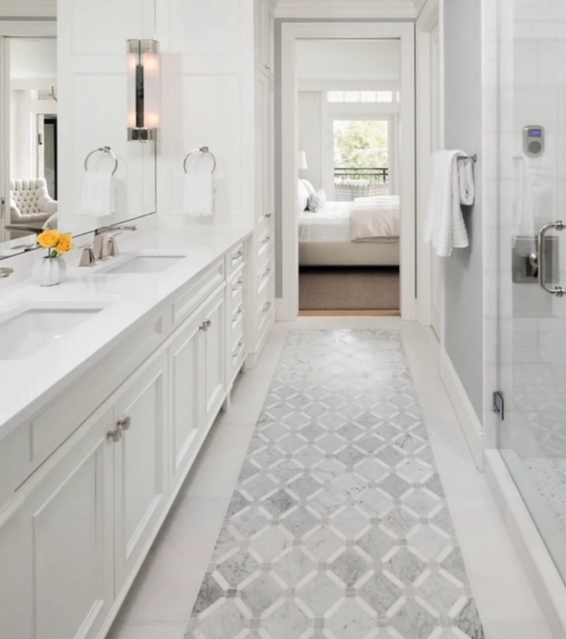 HKB bathroom with a long white vanity, patterned floor tile and a glass shower