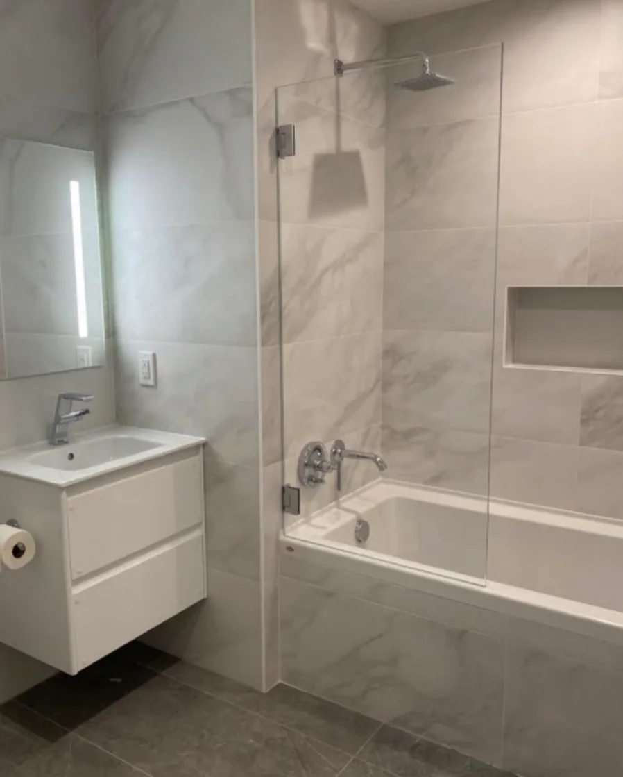 Bathroom with a floating vanity and tub screen from HKB photography