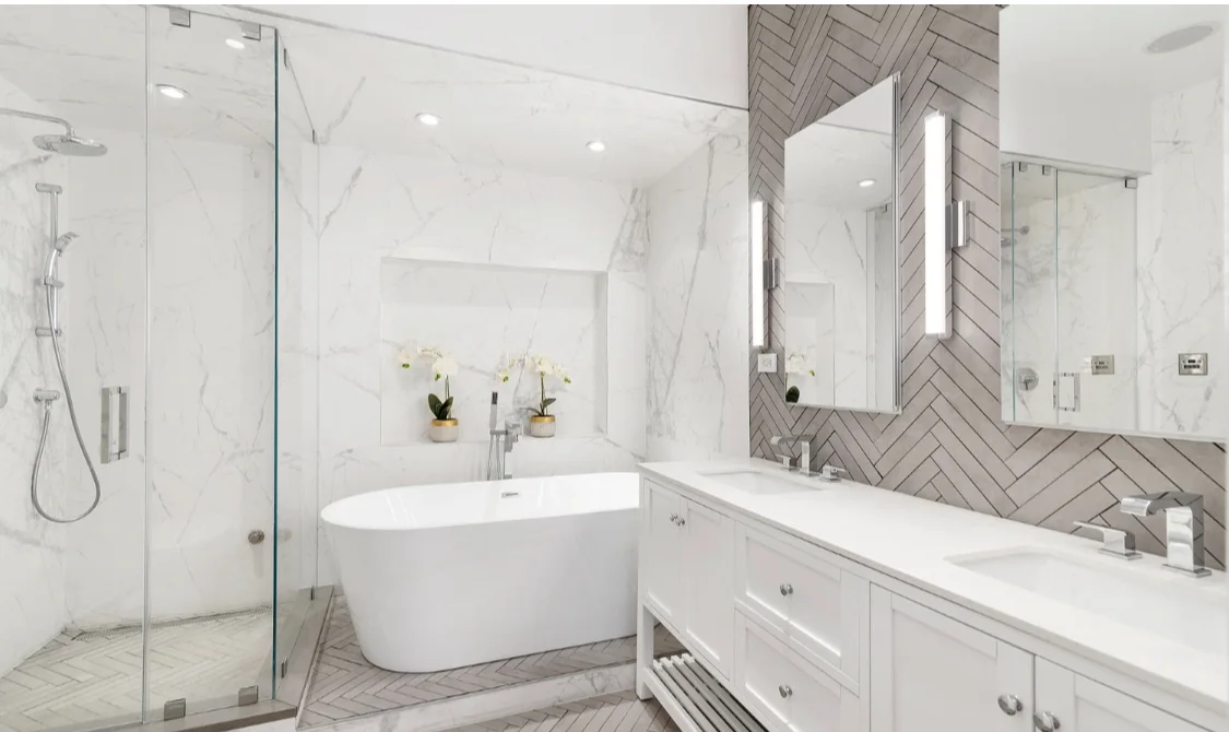HKB bathroom with a freestanding tub, double vanity and glass shower