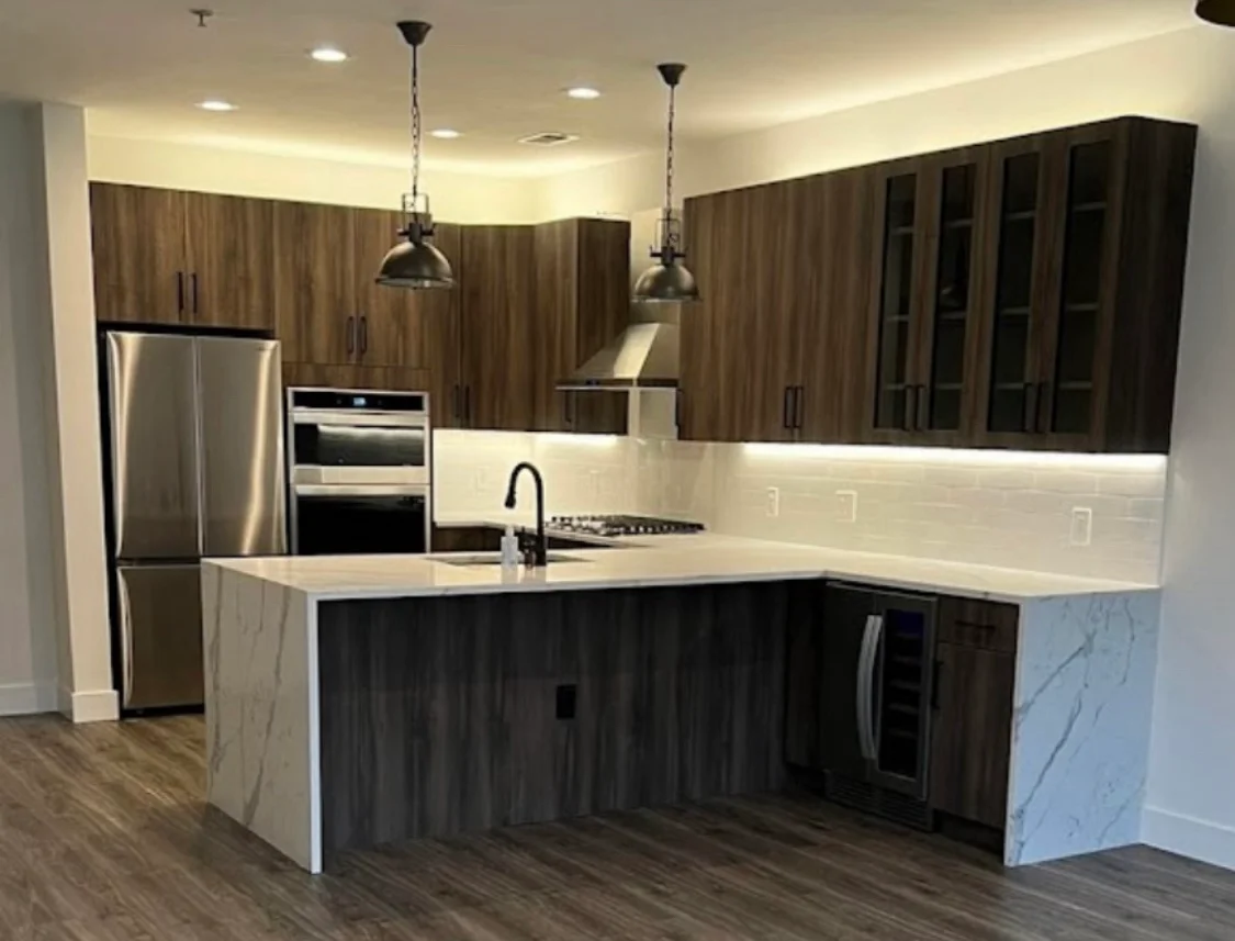 HKB kitchen with dark wood cabinetry and an island