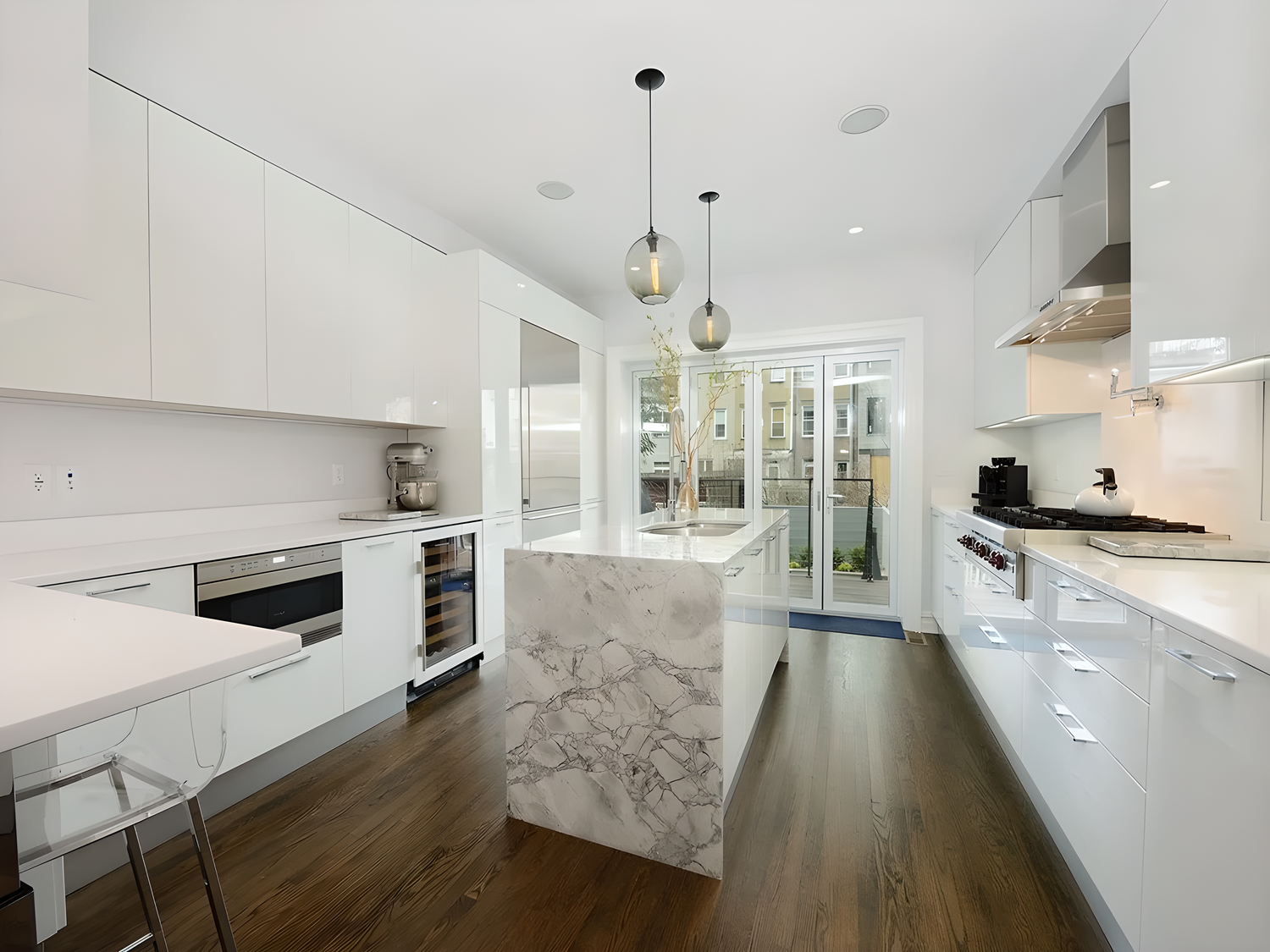 HKB white kitchen with a narrow stone island and dark flooring
